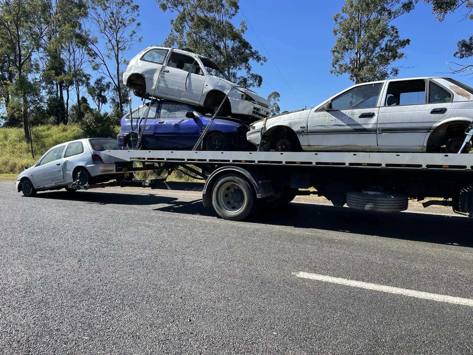 Free car removal truck loaded with unwanted cars in Queensland